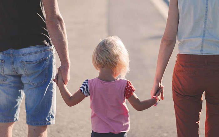 Child holding parents hand