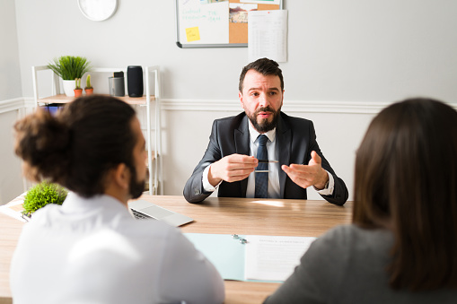 A Divorce Attorney Explaining the Legal Procedure to a Couple Signing the Papers